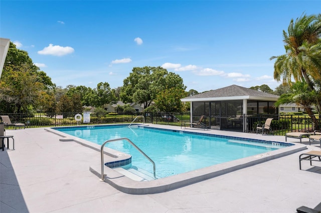 view of pool featuring a sunroom and a patio area