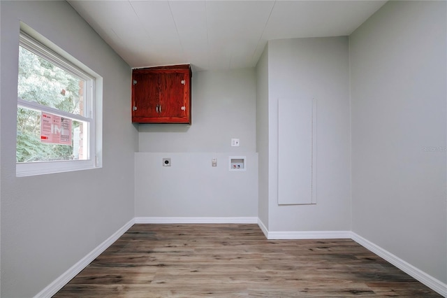 clothes washing area with hookup for an electric dryer, baseboards, washer hookup, wood finished floors, and laundry area