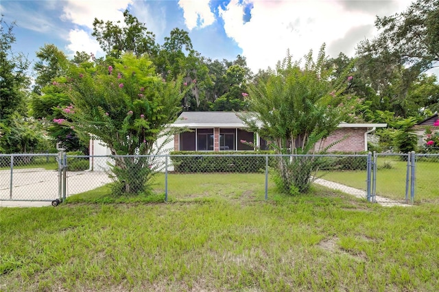view of front of property with fence, a gate, a front yard, and concrete driveway