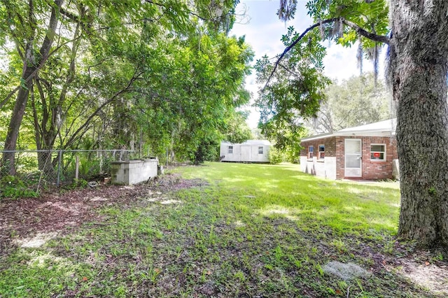 view of yard with an outdoor structure and fence