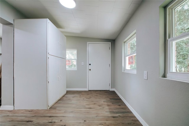 interior space with light wood-type flooring and baseboards