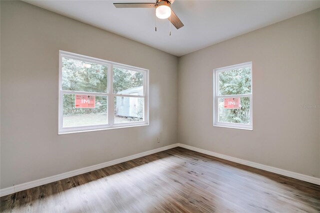 spare room featuring hardwood / wood-style floors and ceiling fan