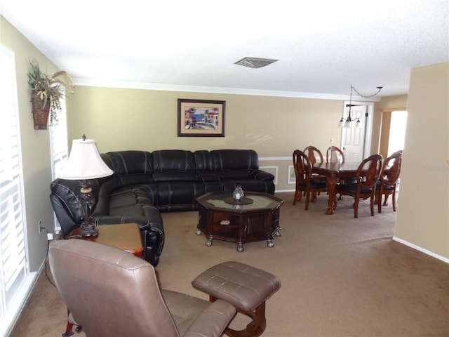 living room with crown molding and carpet floors