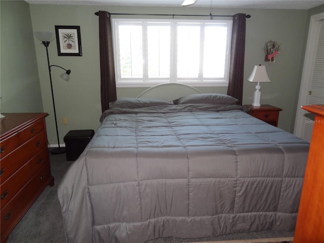 bedroom featuring dark carpet