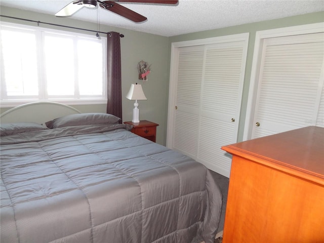 bedroom with ceiling fan and a textured ceiling