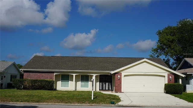 ranch-style home with covered porch, a garage, and a front lawn