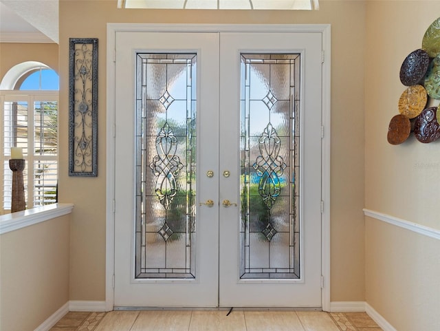 entryway featuring french doors and light tile patterned flooring