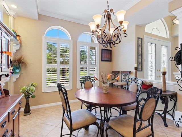 dining room with light tile patterned floors, ornamental molding, and a notable chandelier