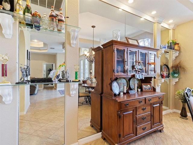 kitchen featuring a healthy amount of sunlight, hanging light fixtures, and ornamental molding