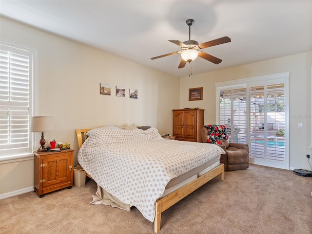 bedroom with access to exterior, ceiling fan, and light carpet