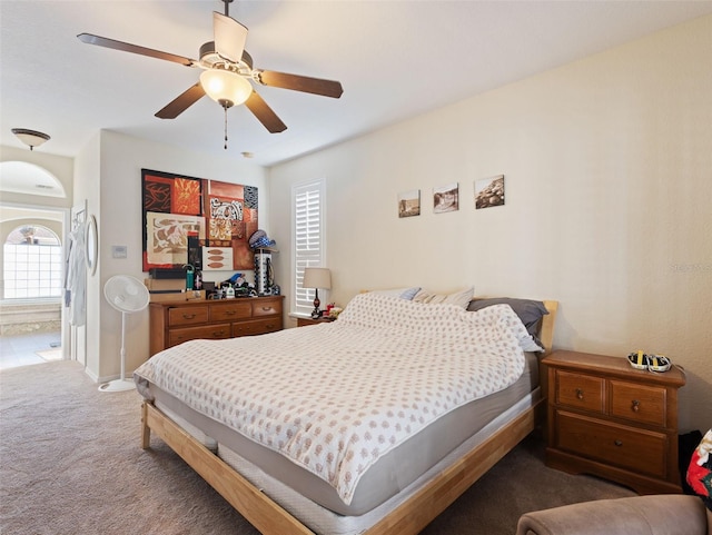 bedroom featuring multiple windows, carpet, and ceiling fan