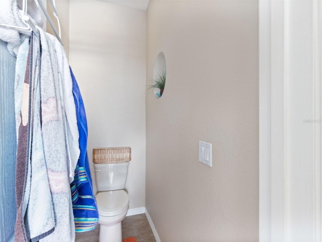 bathroom featuring tile patterned floors and toilet