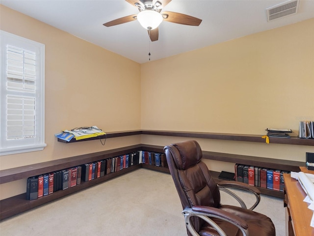 home office with light carpet and ceiling fan