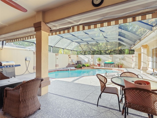 view of pool with a lanai, a patio area, and ceiling fan