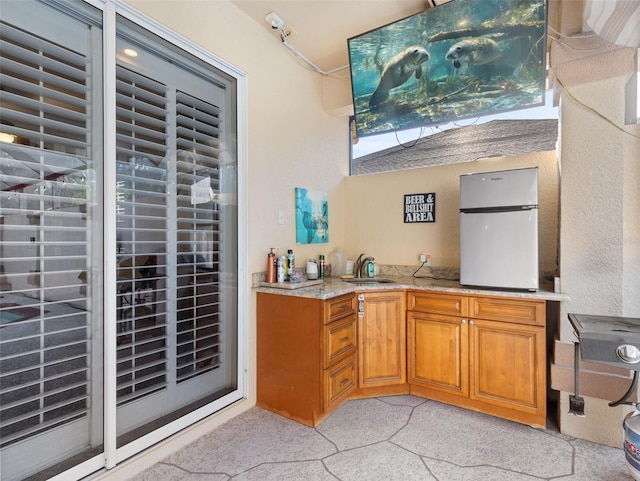 kitchen featuring sink and white refrigerator