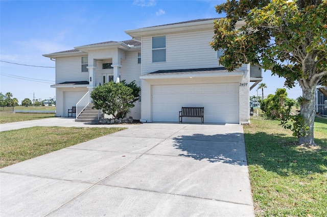 view of front of house with a garage and a front lawn