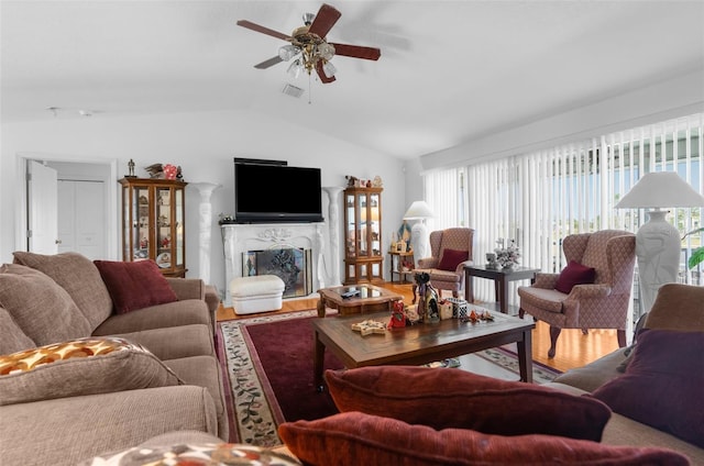 living room with ceiling fan, hardwood / wood-style floors, and lofted ceiling