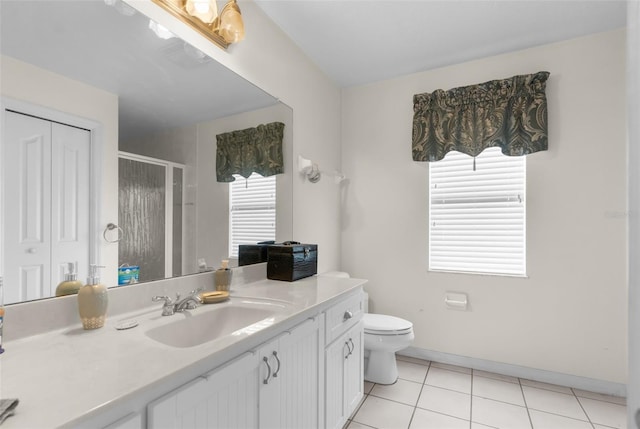 bathroom featuring tile patterned flooring, vanity, plenty of natural light, and walk in shower