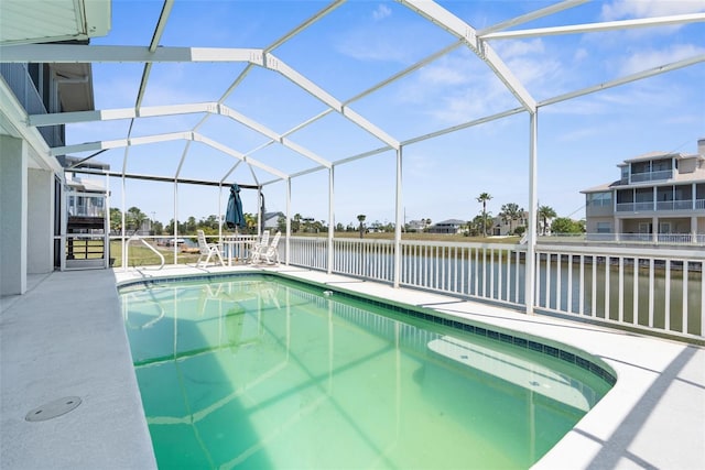 view of swimming pool with a patio area, a lanai, and a water view