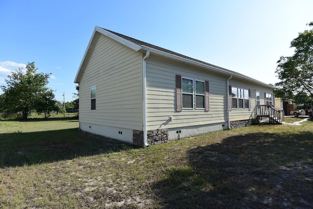 view of property exterior with a yard