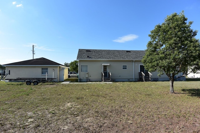 rear view of property with a lawn