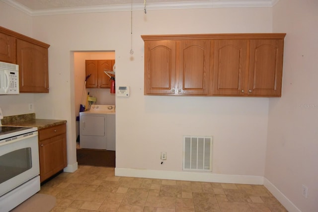 kitchen with ornamental molding, white appliances, and washer / dryer