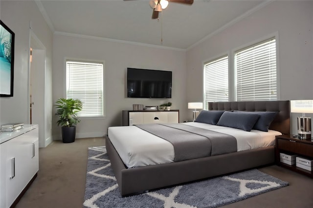 bedroom featuring ceiling fan, ornamental molding, carpet floors, and multiple windows