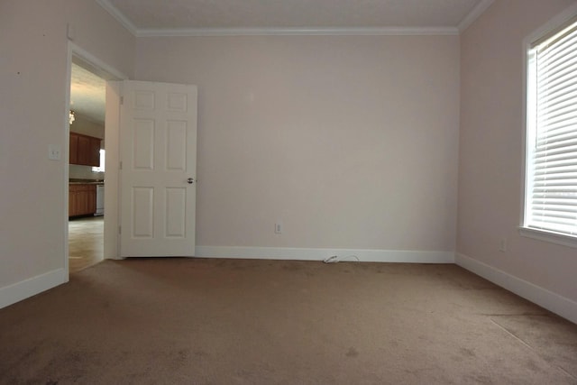 unfurnished room featuring a healthy amount of sunlight, light colored carpet, and ornamental molding