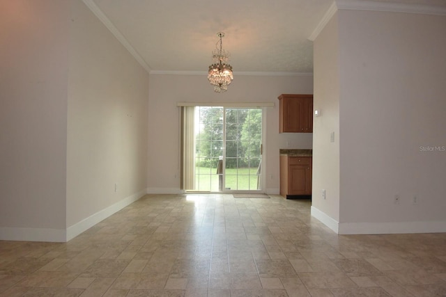 spare room featuring an inviting chandelier and crown molding