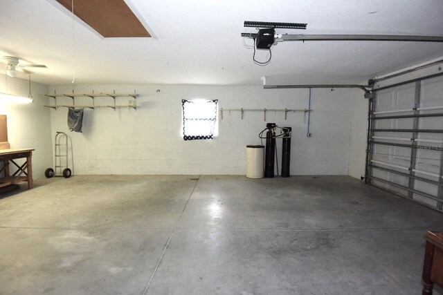 garage with ceiling fan and a garage door opener