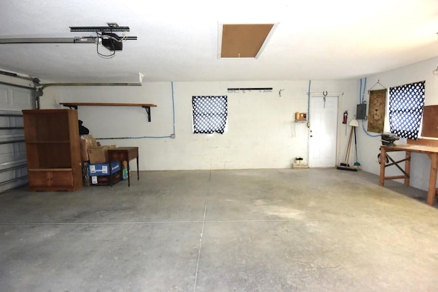 garage with electric panel and a garage door opener