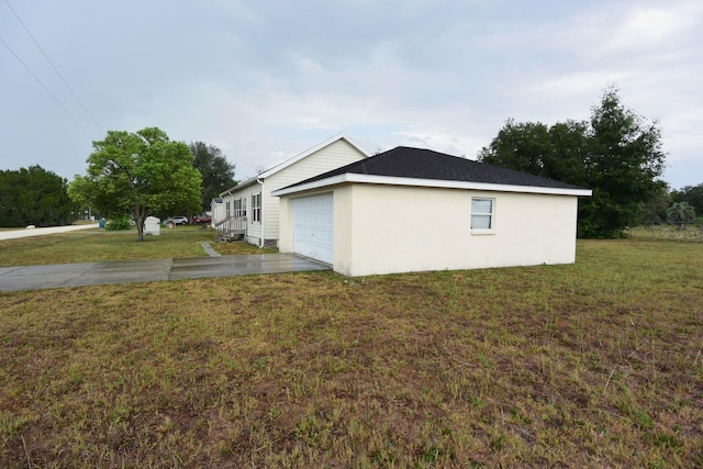 view of home's exterior with a garage and a lawn