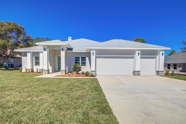 prairie-style house with stucco siding, a garage, stone siding, driveway, and a front lawn