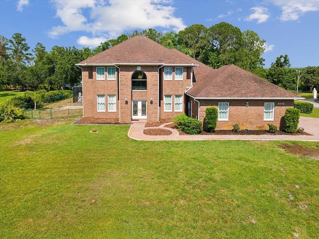 view of front of home featuring french doors and a front yard