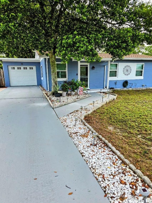 single story home featuring a front yard and a garage