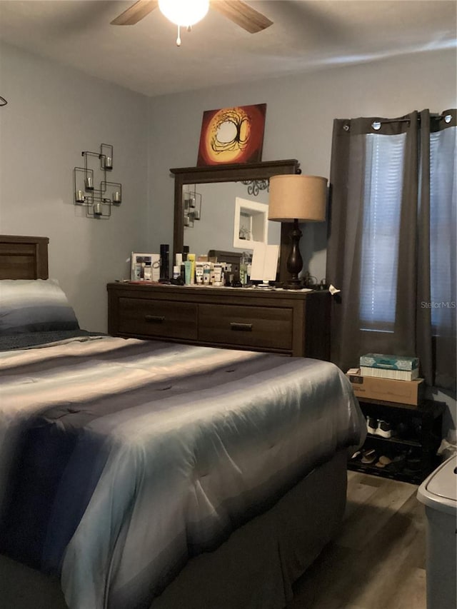 bedroom featuring wood-type flooring and ceiling fan