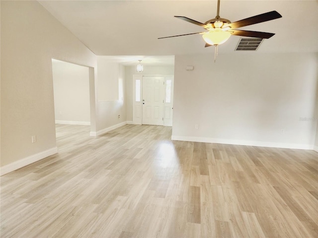 empty room with ceiling fan and light hardwood / wood-style flooring