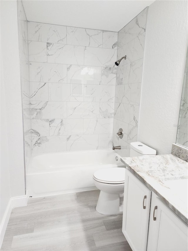 full bathroom with toilet, vanity, hardwood / wood-style floors, and tiled shower / bath