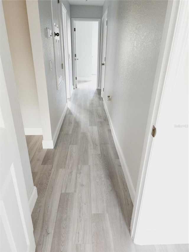 hallway with light wood-type flooring