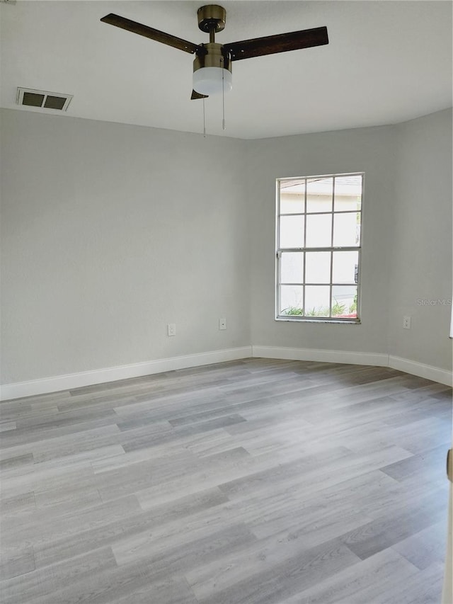 spare room with ceiling fan and light hardwood / wood-style floors