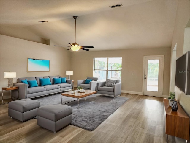 living room with light hardwood / wood-style floors, ceiling fan, and lofted ceiling