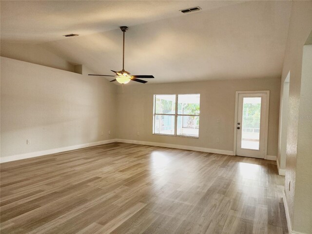 interior space with ceiling fan, light hardwood / wood-style floors, and vaulted ceiling