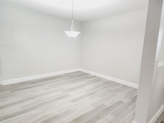 spare room with light hardwood / wood-style floors