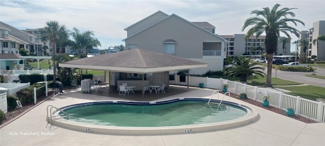 view of pool with a patio and an outdoor bar