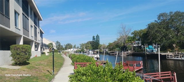 view of property's community featuring a water view and a dock