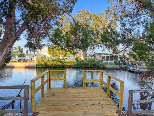 view of dock featuring a deck with water view