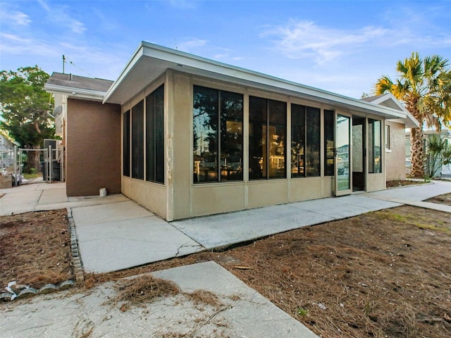 back of house with a sunroom