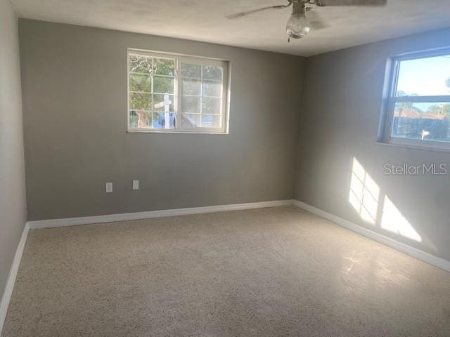 empty room with ceiling fan and carpet