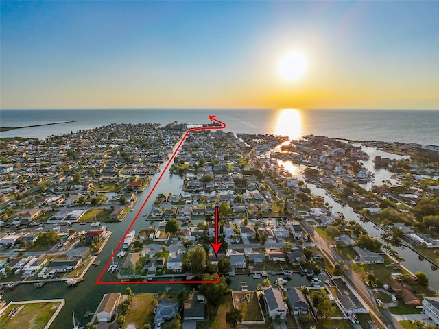 aerial view at dusk with a water view