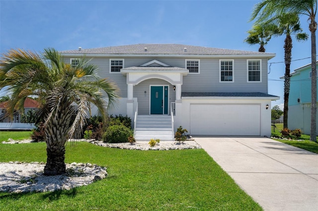 raised ranch with a garage and a front lawn